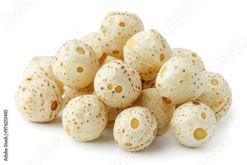 A pile of white and brown speckled wooden beads for decorative or craft use