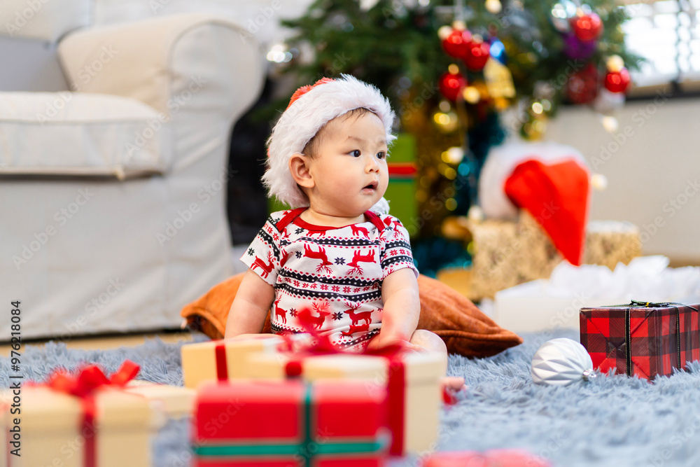 Baby in red hat on Christmas Day, filled with camera, presents and Christmas tree. Baby in red hat on Christmas Day, filled with camera, presents and Christmas tree.