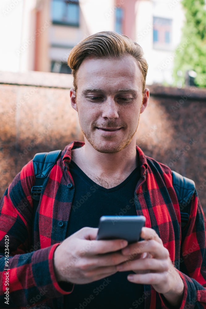 Focused man watching mobile phone in street Focused man watching mobile phone in street