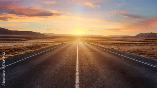 an empty, open road leading into the distance, surrounded by a vast desert landscape