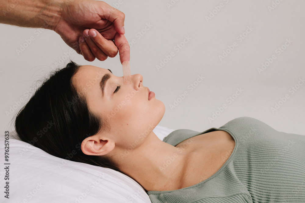 Φωτογραφία Bandaging nose after rhinoplasty or septoplasty to prevent bleeding and bruising