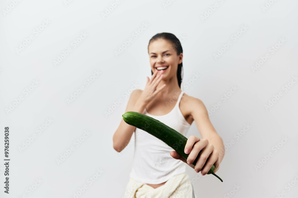 Cucumber humor, playful woman, laughing, fresh vegetable, healthy eating, white background, casual style A cheerful girl holds a cucumber, conveying fun and light heartedness Cucumber humor, playful woman, laughing, fresh vegetable, healthy eating, white background, casual style A cheerful girl holds a cucumber, conveying fun and light heartedness