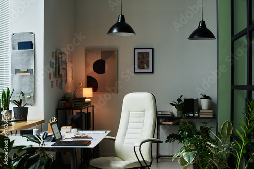 Home office boasting modern decor and ample natural light, featuring minimalist furniture and various plants enhancing productivity and comfort amidst a serene environment photo