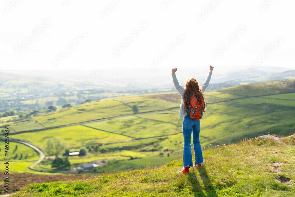 Woman Celebrating on Hilltop With Panoramic View of Rolling Green Hills During Daytime Adventure Woman Celebrating on Hilltop With Panoramic View of Rolling Green Hills During Daytime Adventure