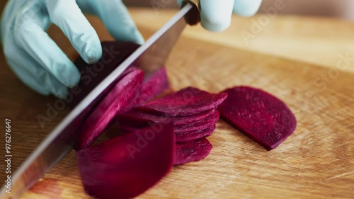 Clean cooking. Woman cutting fresh beetroot in protective gloves, close up