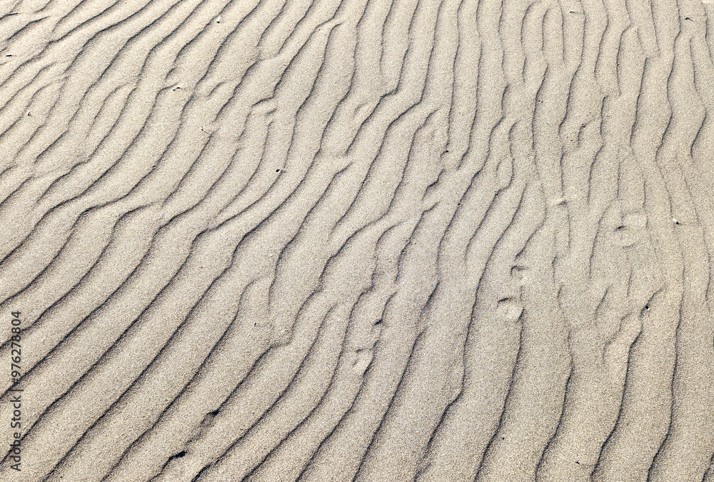 Beautiful sand waves created by the wind on the seashore