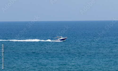 A speed boat cruising in the Mediterranean Sea in summer holiday season