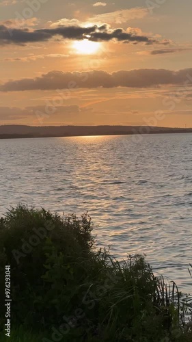 Sunset Over Calm Lake with Reflections of Golden Light