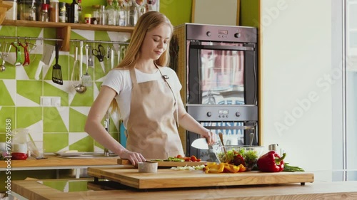 Preparing dinner at home, Young woman cutting fresh tomatoes for vegetable salad at kitchen
