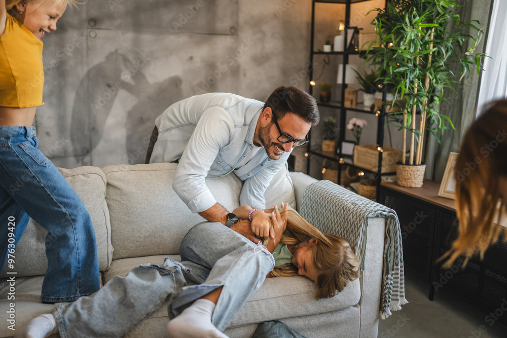 Father tickling daughter and have fun at home Father tickling daughter and have fun at home