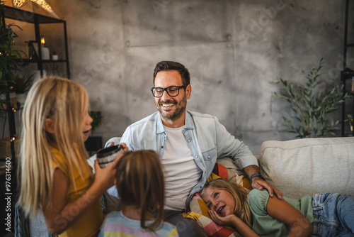 Canvas Print Father and two daughters take care of oldest daughters who has a cold