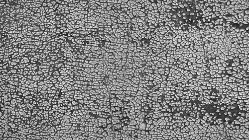 Obraz na plátne The image is a close up of a wall with a lot of cracks and holes