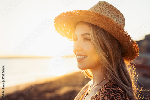 Portrait of one young woman at the beach looking at the sea enjoying free time and freedom outdoors. Having fun relaxing and living happy moments.. #976326646