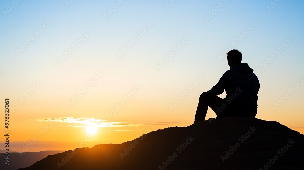 A lone figure sits on a mountaintop, silhouetted against the golden glow of a sunrise or sunset, reflecting tranquility, introspection, and solitude. A lone figure sits on a mountaintop, silhouetted against the golden glow of a sunrise or sunset, reflecting tranquility, introspection, and solitude.