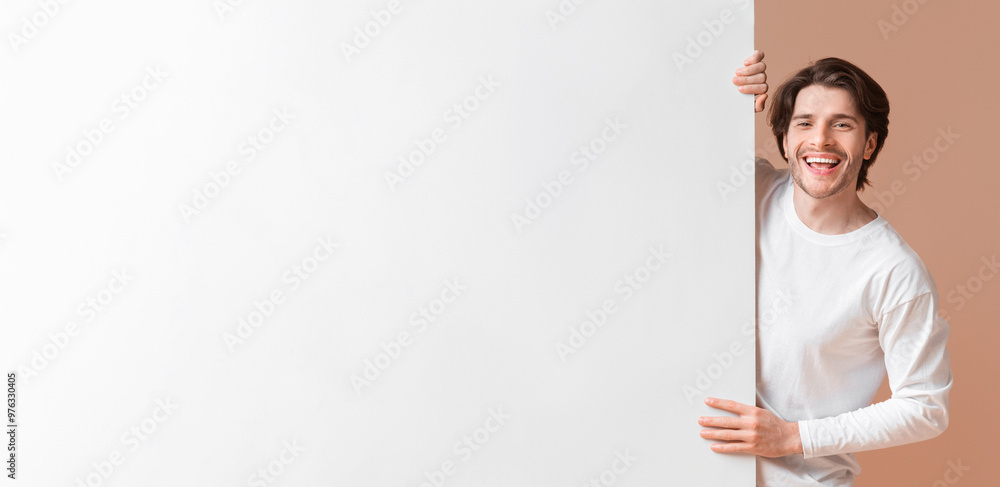 Free Space For Your Ad. Happy Interracial Couple Holding Big White Advertisement Board, Standing Together Over Yellow Background Free Space For Your Ad. Happy Interracial Couple Holding Big White Advertisement Board, Standing Together Over Yellow Background