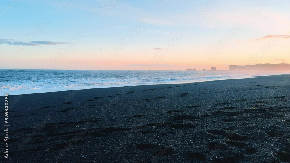 Summer scene at sunset with black beach, sand and Vestrahorn mountain in Hofn, Iceland. A popular place among tourists, a black beach during big waves and a pink sunset. Iceland, Vik.