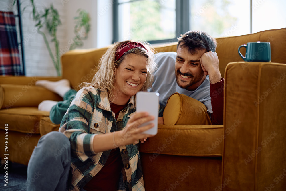 Happy couple taking selfie with cell phone at home. Happy couple taking selfie with cell phone at home.