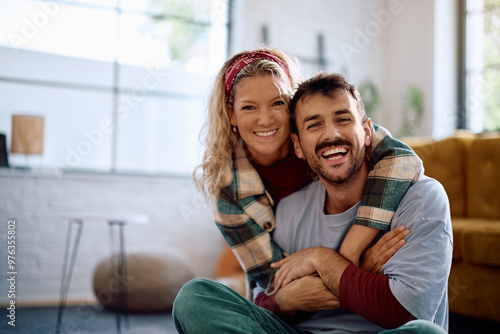 Portrait of happy couple at home looking at camera.