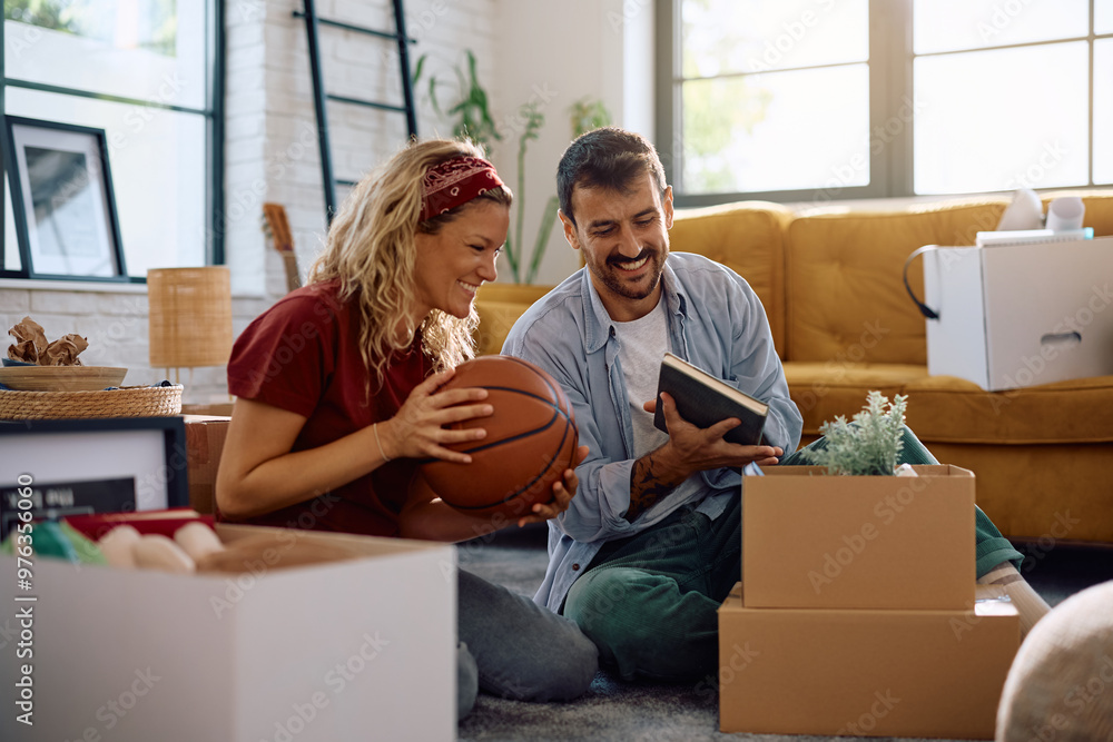 Carefree couple enjoying while unpacking in their new home. Carefree couple enjoying while unpacking in their new home.
