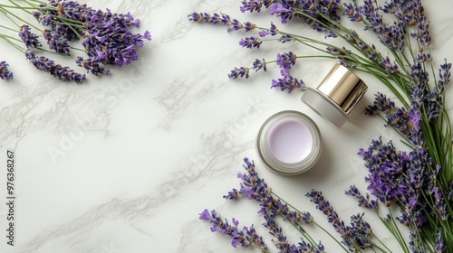 Lavender flowers paired with skincare products on a marble surface during day...