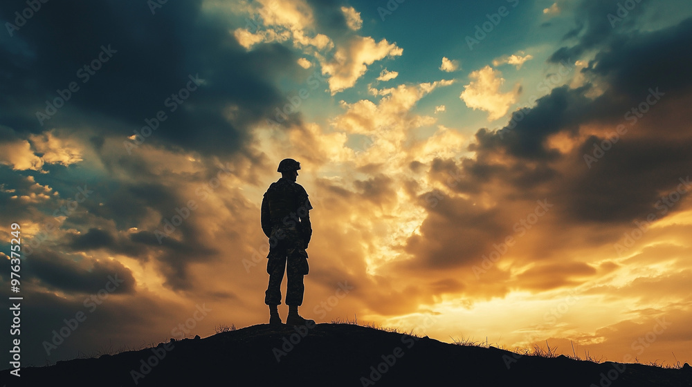 Soldier Silhouetted on Hilltop Against Vibrant Sunset Clouds Soldier Silhouetted on Hilltop Against Vibrant Sunset Clouds
