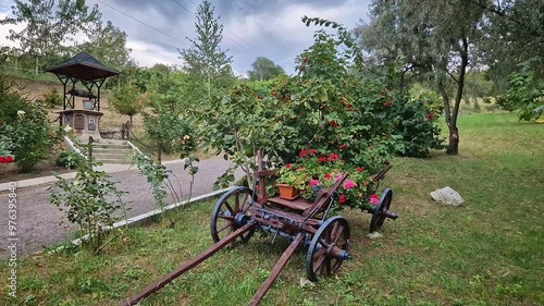 Wallpaper Mural Countryside vintage style oxcart decorated with blooming flowers. Old wooden cart as decorative element in a rural yard next to a water well Torontodigital.ca