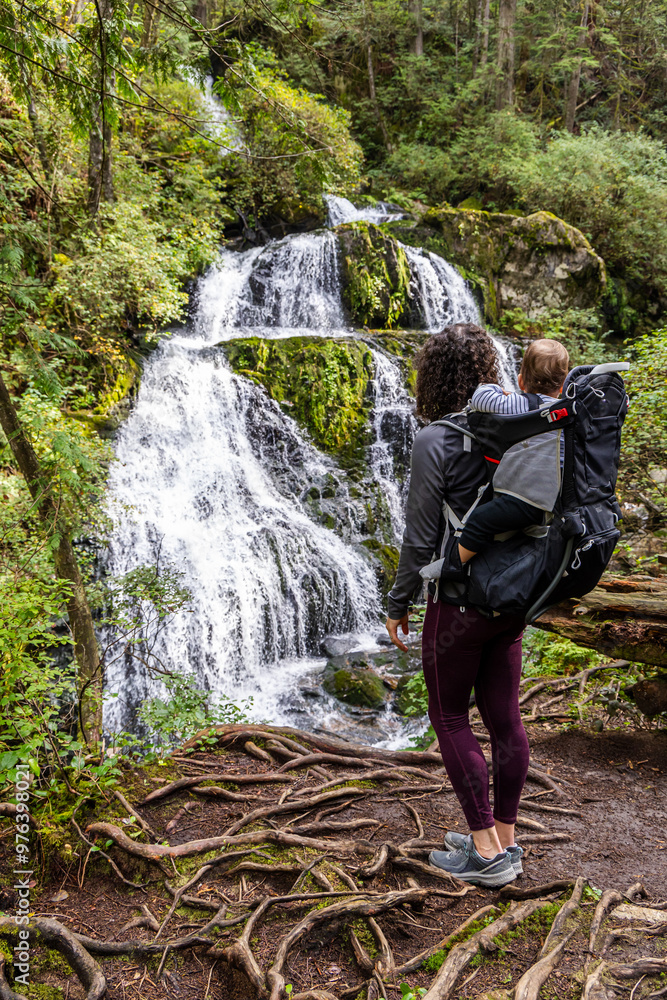 Obraz premium Mother Hiking with Baby in Backpack, Scenic Waterfall, Mission, British Columbia, Canada