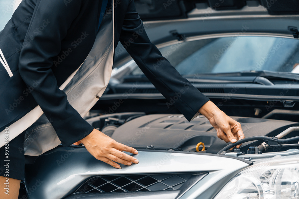 A business woman whose car breakdown try to fix the car by herself without help. uds A business woman whose car breakdown try to fix the car by herself without help. uds