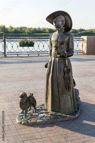 Russia. Astrakhan. Sculptural composition of a lady with a dog on Petrovskaya embankment. photo