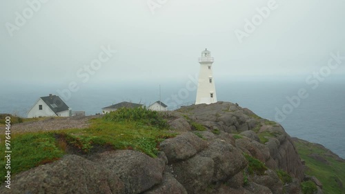 The Cape Spear lighthouse beacon serves as a warning to ships on a foggy day in Newfoundland photo