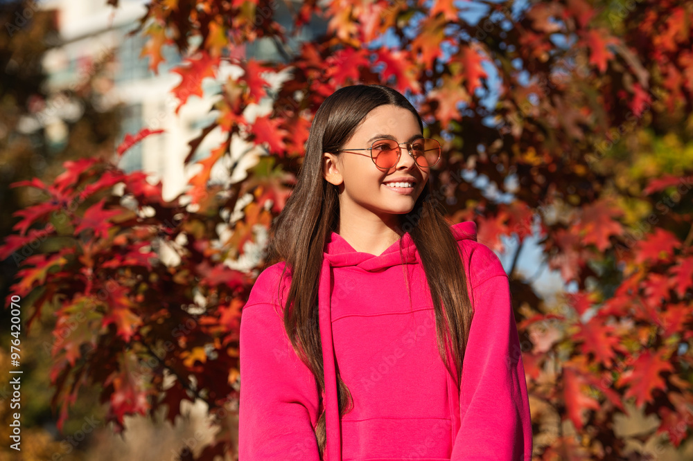 Fall concept. Girl in autumn style outdoor. Fall style fashion. Autumn leaves and happy young girl in forest. The color and mood of autumn. Teenager girl in the autumn park. Warm days