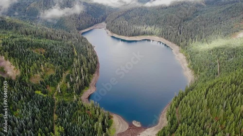 Forest woods and calm tranquil mountanian lake.