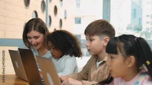 Smart teacher teaching and looking student using laptop at classroom. Professional instructor explained about programing engineering code or prompt while studying and learning program. Erudition. photo