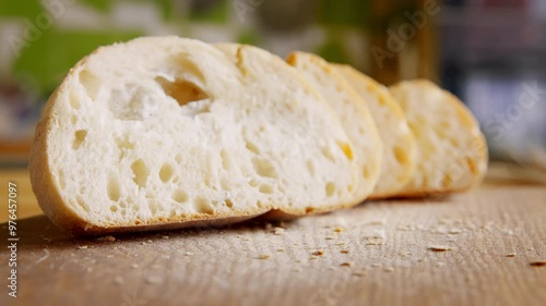 Freshly baked cut bread on rustic kitchen table, close up, stop motion