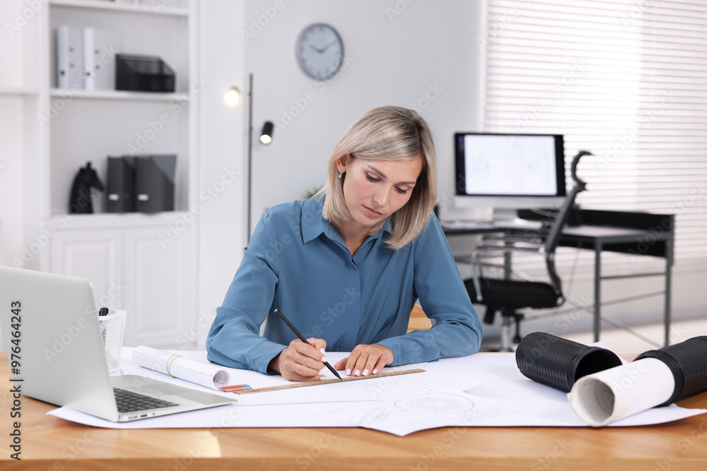 Architect making engineering drawing at wooden table in office Architect making engineering drawing at wooden table in office