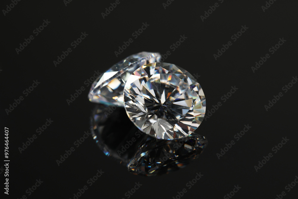 Beautiful shiny diamonds on black mirror surface, closeup Beautiful shiny diamonds on black mirror surface, closeup