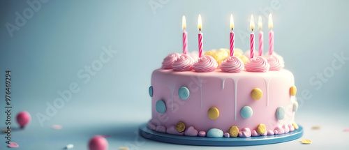 A beautiful pink birthday cake with colorful sprinkles and candles, perfect for festive celebrations and special occasions. photo