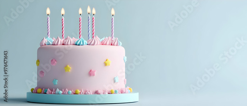 A delightful pastel birthday cake adorned with candles and decorations, perfect for celebrations and festive occasions. photo