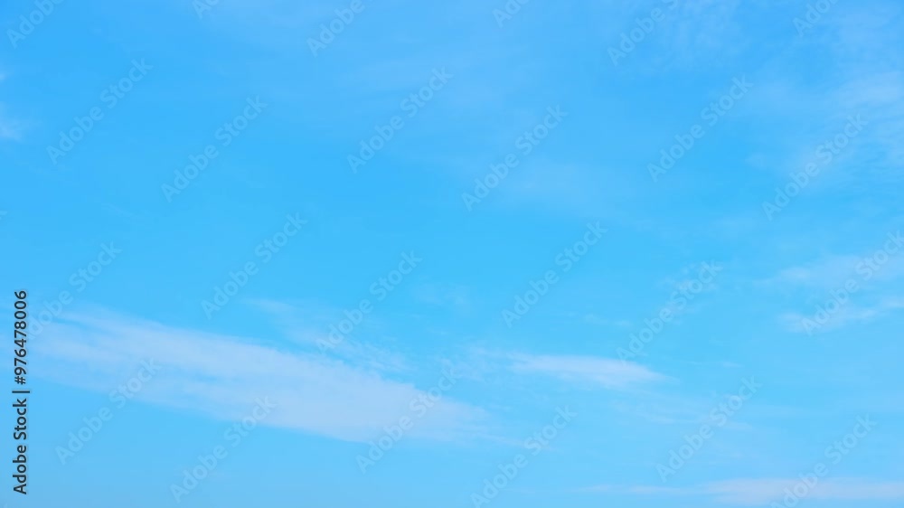 Time-lapse magic unveils the beauty of a dynamic blue sky, where clouds swirl and shift in a display of nature's motion, casting a spellbinding aura over the horizon. Cloudscape background. Timelapse. Time-lapse magic unveils the beauty of a dynamic blue sky, where clouds swirl and shift in a display of nature's motion, casting a spellbinding aura over the horizon. Cloudscape background. Timelapse.