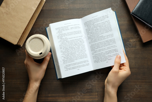 Books with a cup of coffee on a wooden background