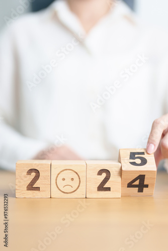 2024 end year to Happy New Year 2025 with Sad face block. Satisfaction, feedback, Review, mental health, eco sustainable and bad year concept
