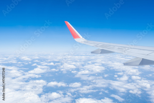 Airplane wing, Clouds and blue sky has seen through the window of an aircraft view