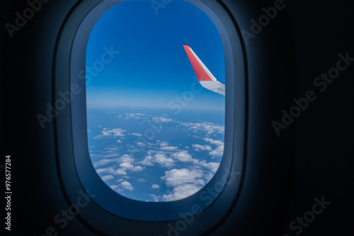 Airplane wing, Clouds and blue sky has seen through the window of an aircraft view
