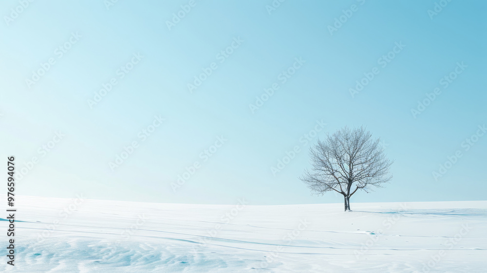 Minimalist winter landscape with a single bare tree on a snow-covered field under a clear blue sky Minimalist winter landscape with a single bare tree on a snow-covered field under a clear blue sky