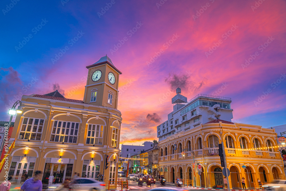 Fototapeta premium Pink cloud in blue sky above The classic building in Phuket old town. Scene of romantic beautiful sky sunset with slow moving cloud in the sky background. The clock tower is a landmark of Phuket.