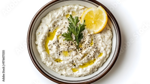 Creamy tzatziki dip with lemon and parsley garnish