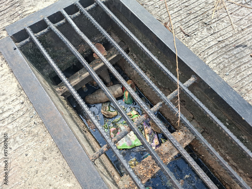 garbage stuck in ditches, which can clog and cause flooding photo