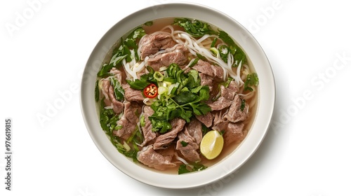 Delicious vietnamese pho with beef, fresh herbs, and lime in a white bowl on white background photo