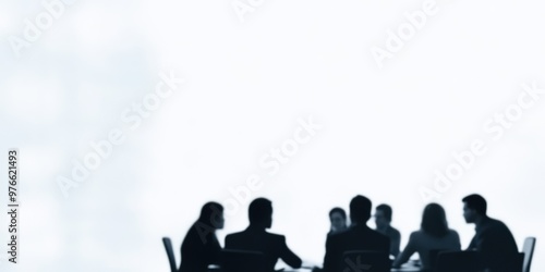 Silhouettes of business people sitting around a conference table having a discussion, representing professional teamwork, collaboration, and corporate environment. photo