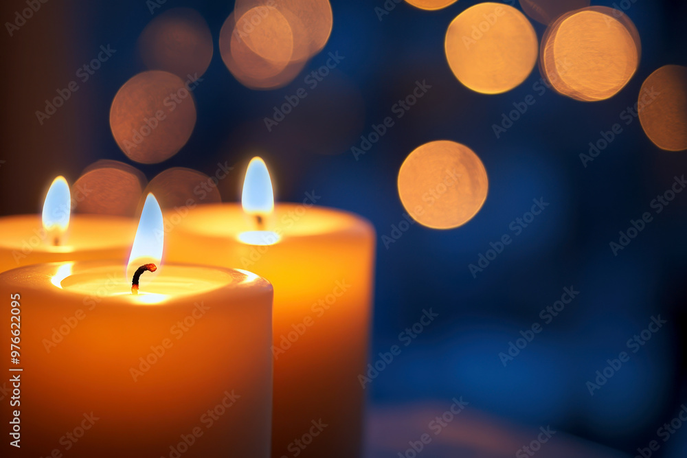Warm candles glowing softly beside blur background. Warm candles glowing softly beside blur background.
